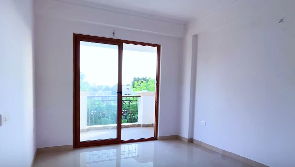 A room opening onto its balcony through full-height sliding doors